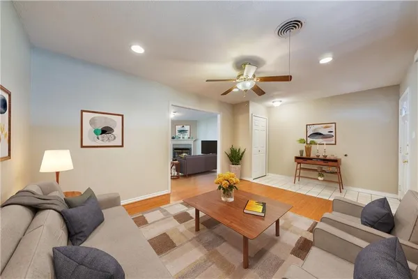 a living room with furniture a rug and a chandelier