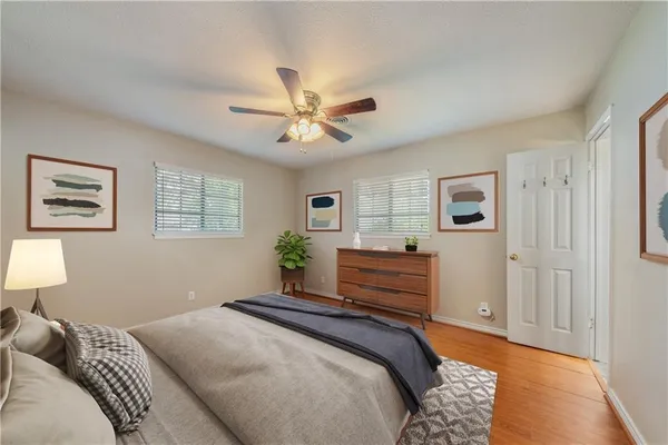 a bedroom with a bed dresser and a window