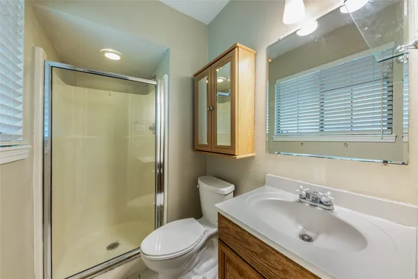 a bathroom with a sink toilet and shower