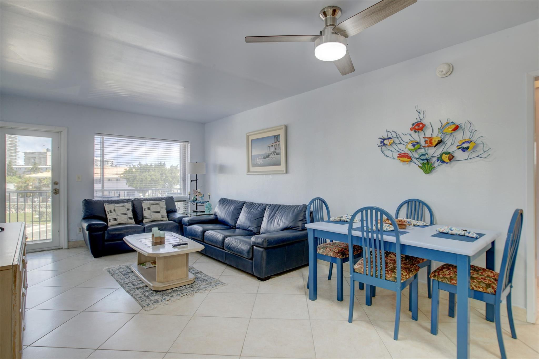999 North Riverside Drive, Unit 11 Pompano Beach, FL 33062 - Photo 4 of 12 a living room with furniture and a large window