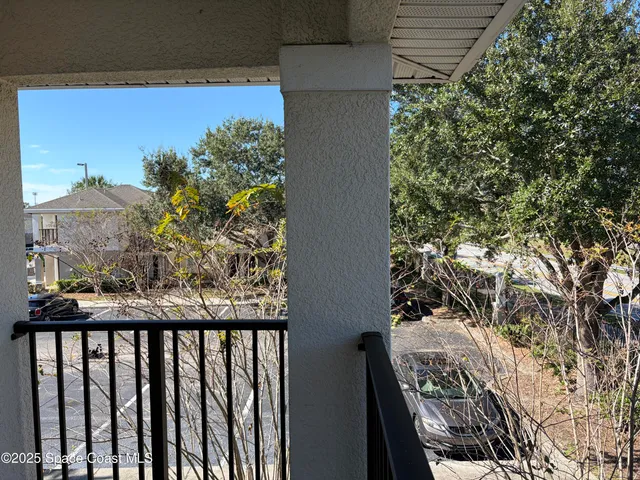 a view of balcony with wooden floor and a bench