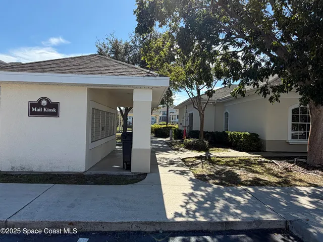 a view of a house with yard and sitting area