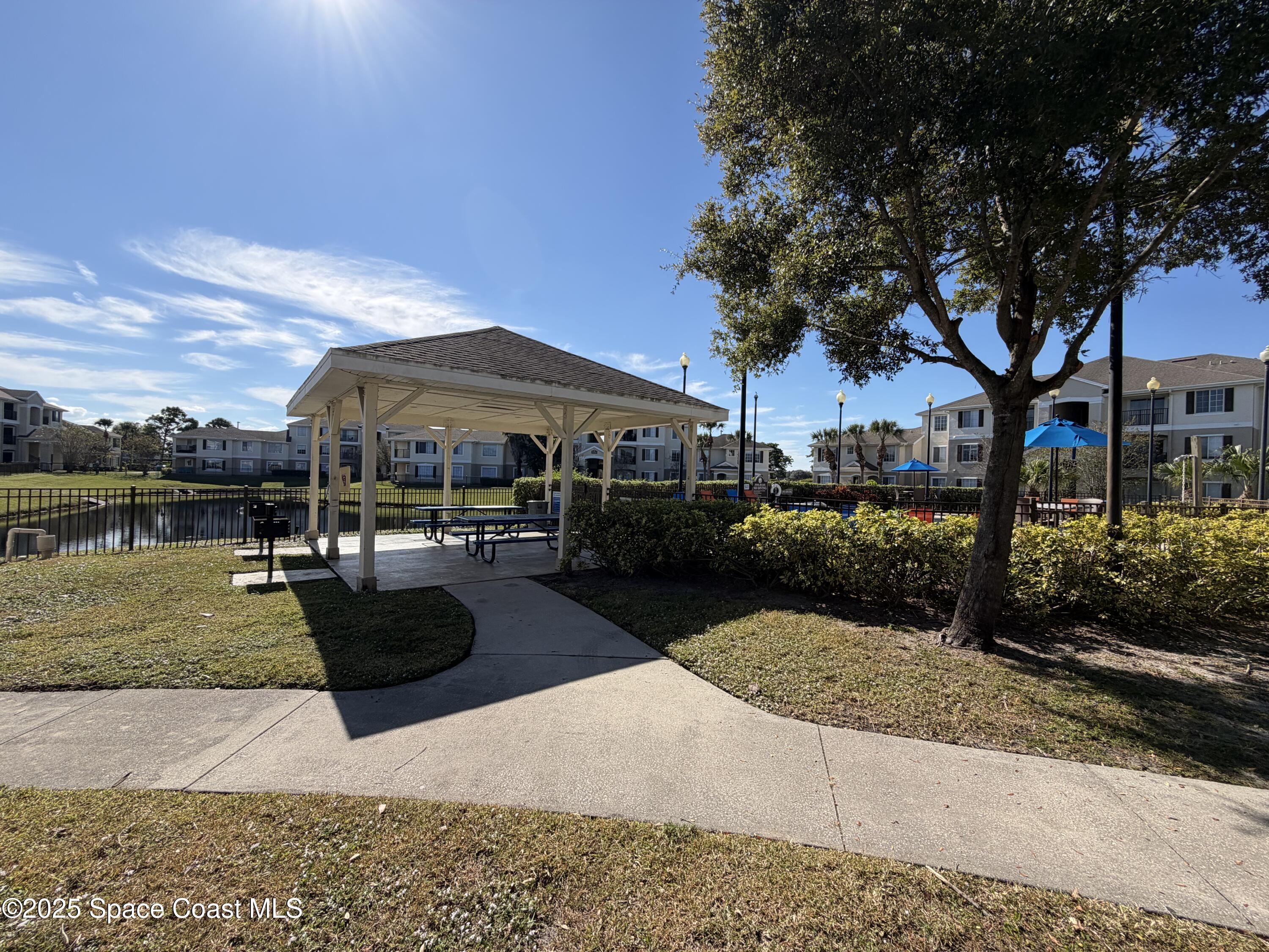 3511 D D'Avinci Way, Unit 2012 Melbourne, FL 32901 - Photo 20 of 26 a view of a house with yard and sitting area