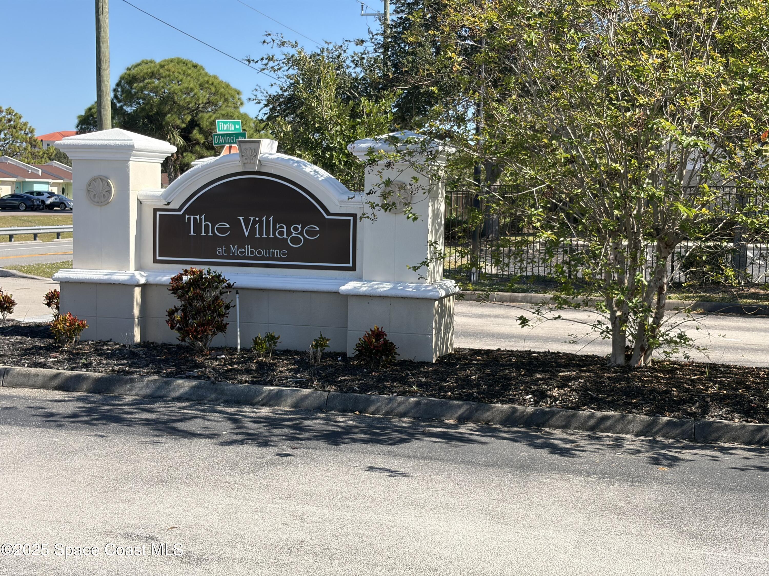 3511 D D'Avinci Way, Unit 2012 Melbourne, FL 32901 - Photo 26 of 26 a front view of a house with a yard