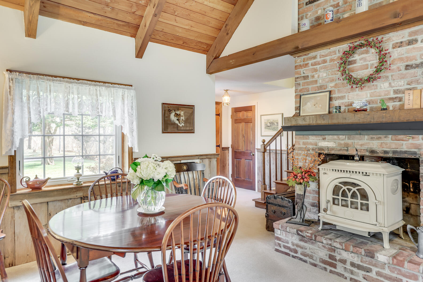 84 Beach Road Orleans, MA 02653 - Photo 11 of 45 a living room with furniture a fireplace and a table
