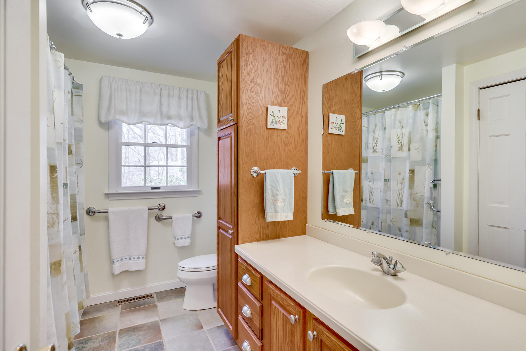 84 Beach Road Orleans, MA 02653 - Photo 15 of 45 a bathroom with a sink a toilet and shower