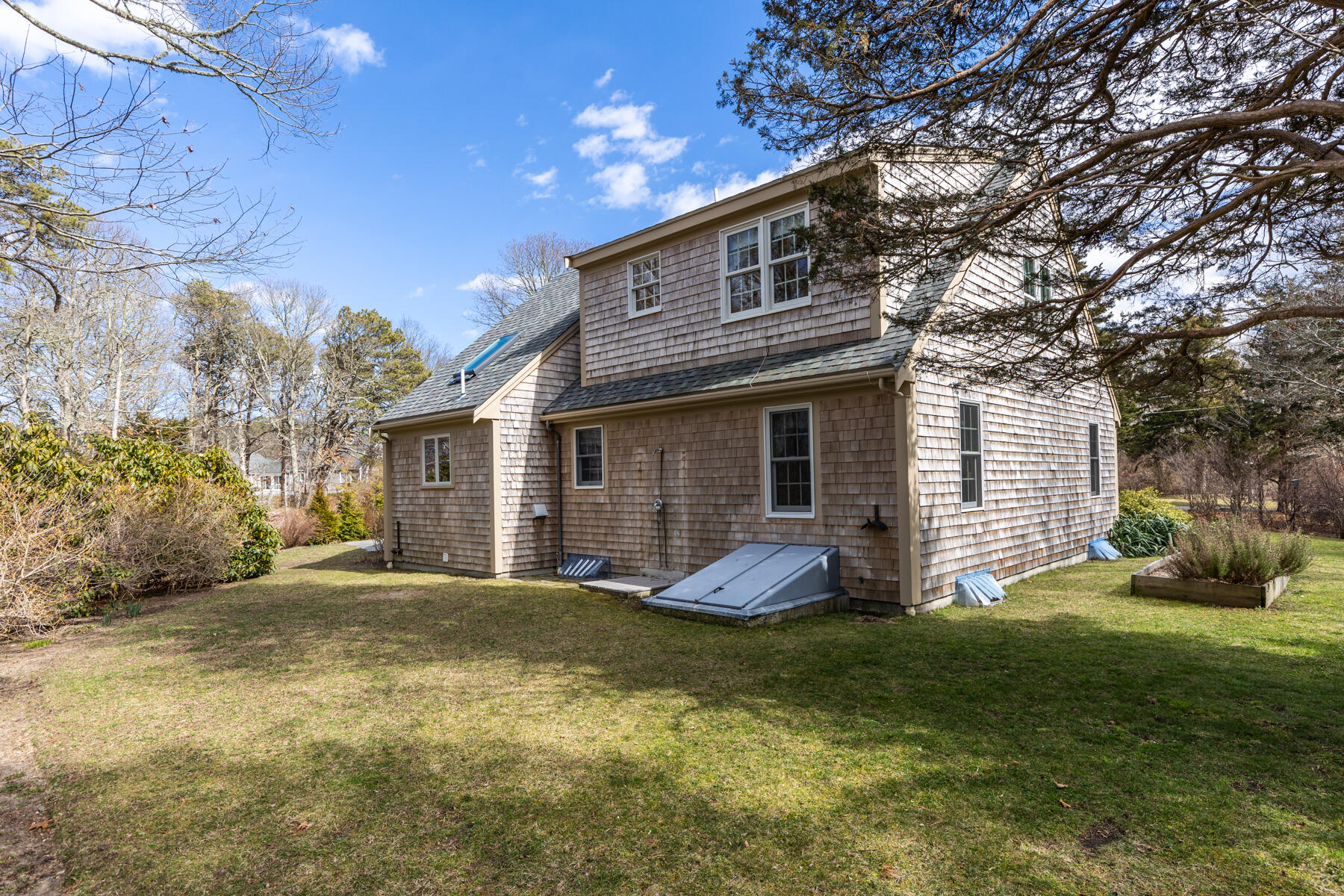 84 Beach Road Orleans, MA 02653 - Photo 27 of 45 a view of a house with a yard