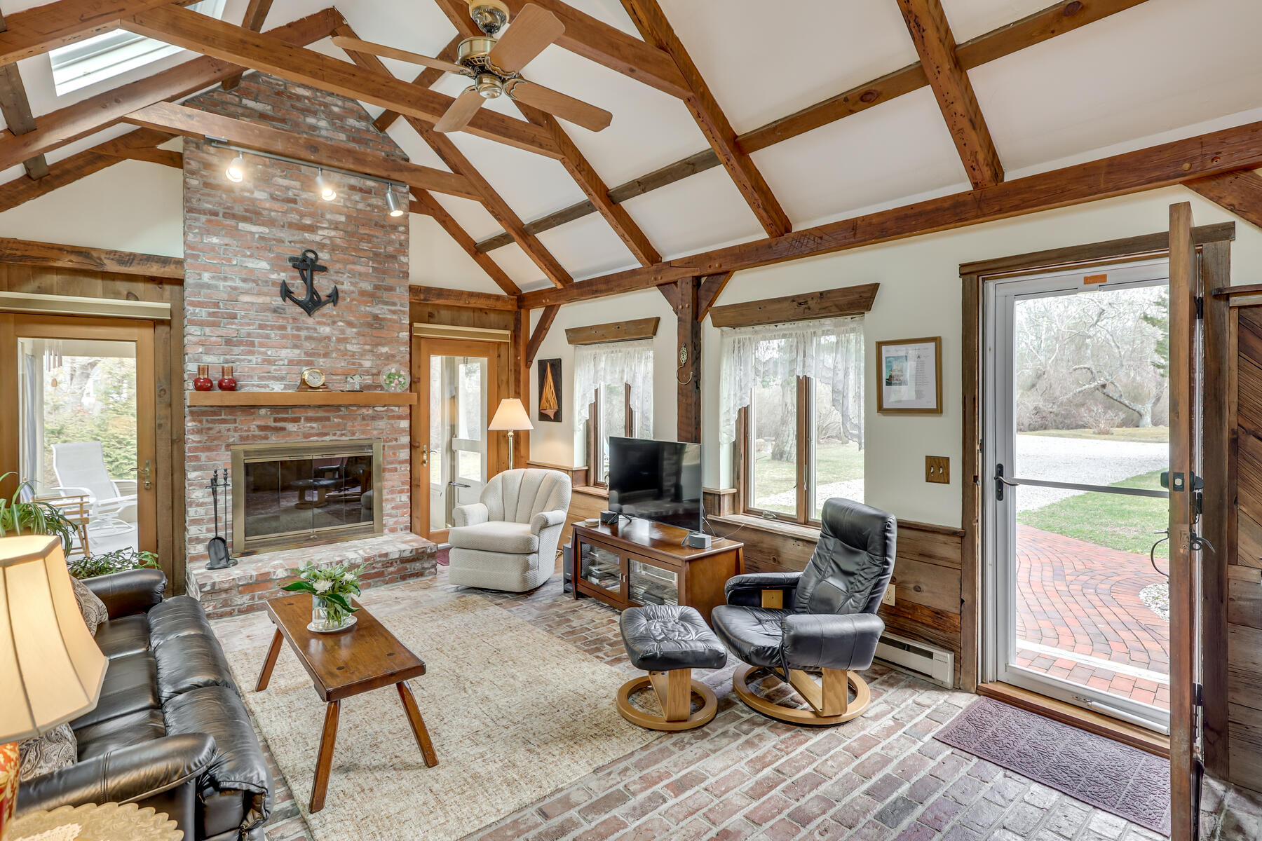 84 Beach Road Orleans, MA 02653 - Photo 6 of 45 a living room with furniture and a fireplace