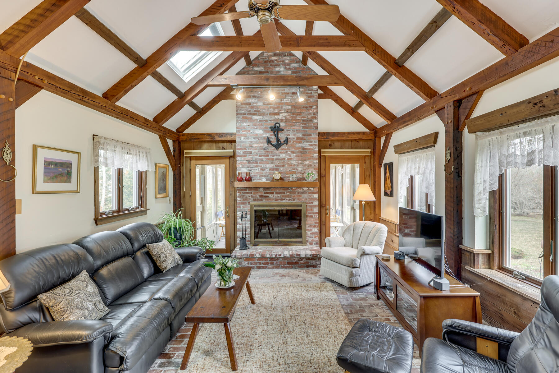 84 Beach Road Orleans, MA 02653 - Photo 7 of 45 a living room with furniture and a fireplace