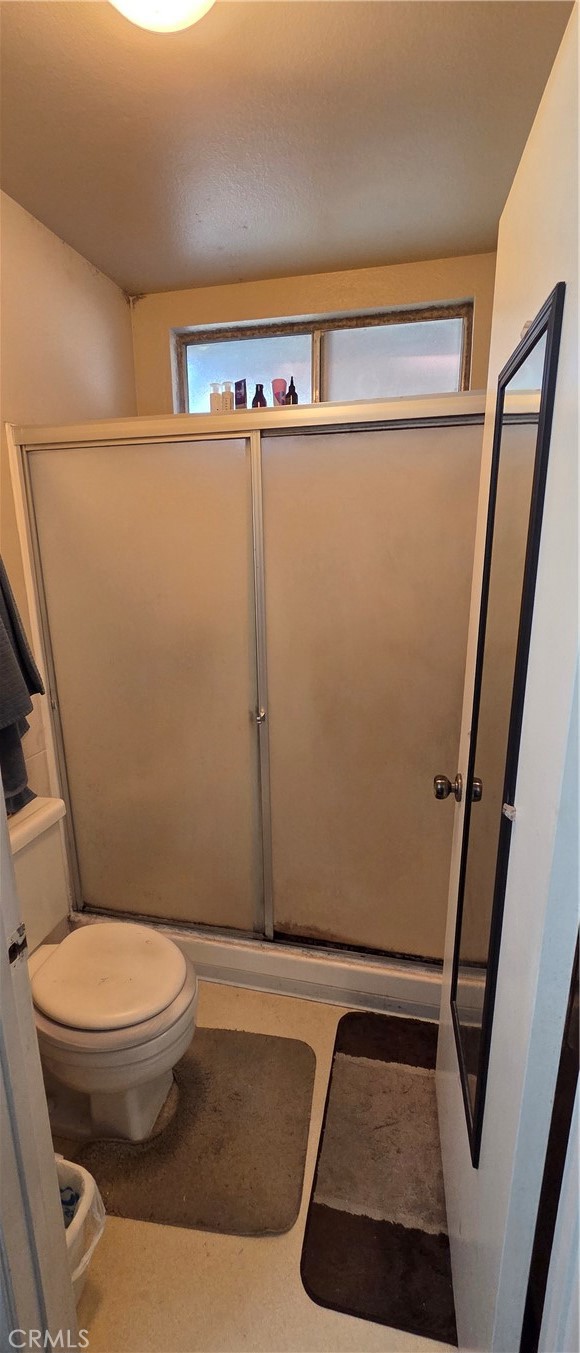 1548 Ranch Road San Bernardino, CA 92407 - Photo 22 of 26 a bathroom with a toilet and a shower