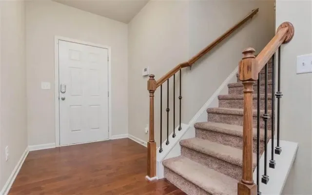 a view of kitchen with granite countertop cabinets and chandelier