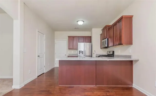 a view of kitchen with granite countertop cabinets and sink