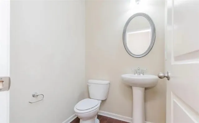 a view of kitchen and empty room with wooden floor