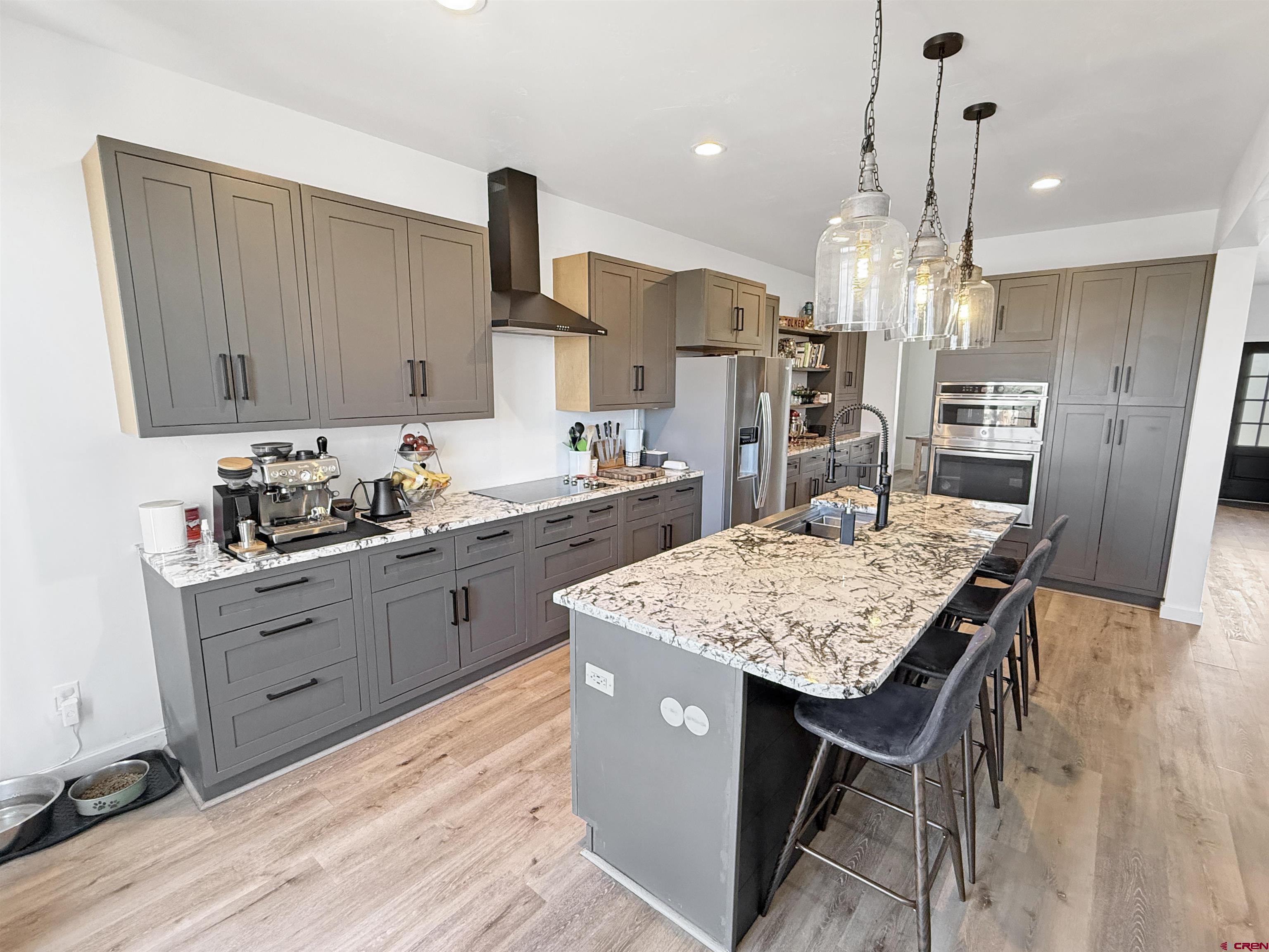 903 South Oak Street Cortez, CO 81321 - Photo 12 of 44 a kitchen with a table chairs refrigerator and cabinets