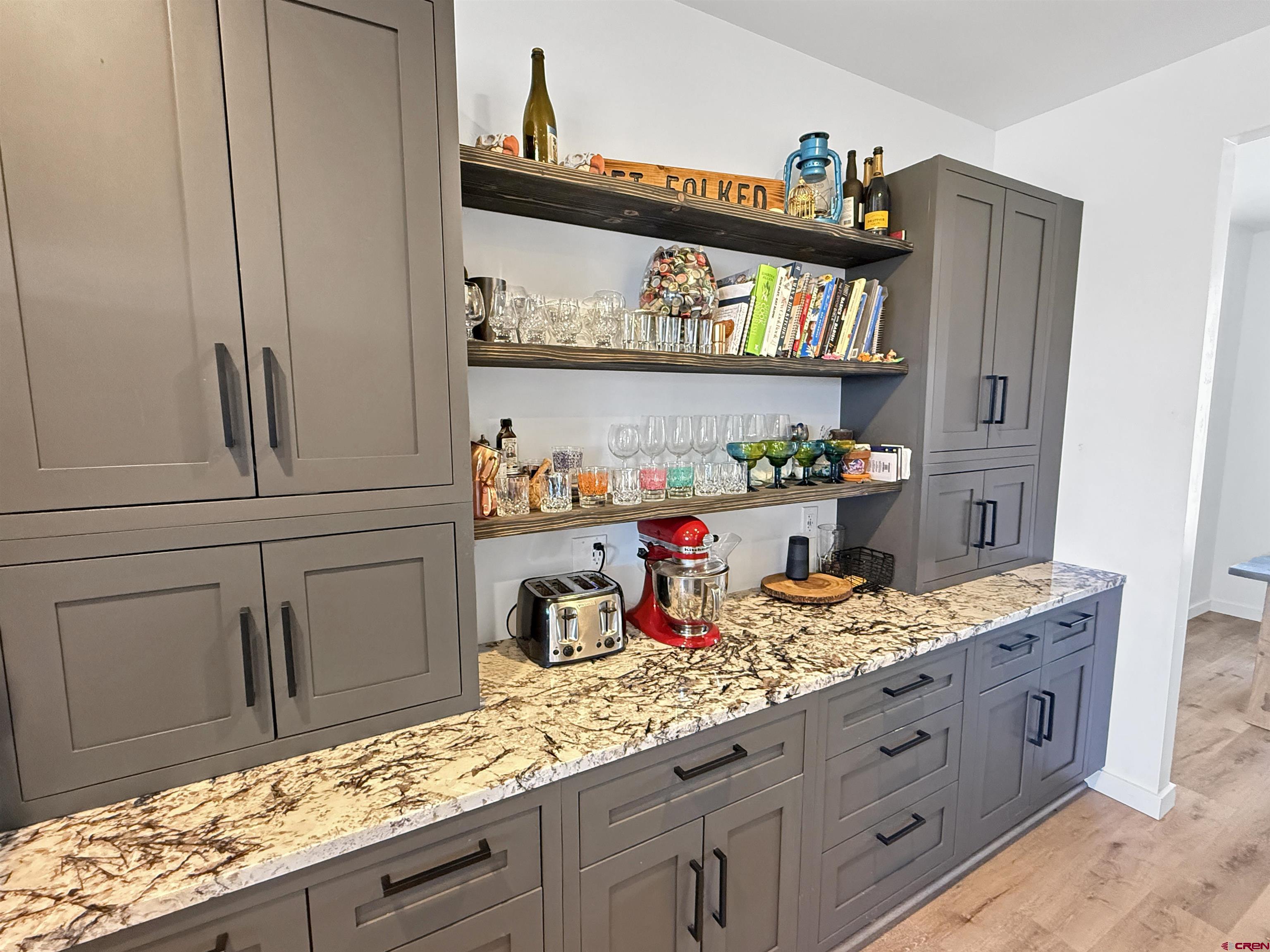 903 South Oak Street Cortez, CO 81321 - Photo 13 of 44 a kitchen with granite countertop lots of clutter and cabinets
