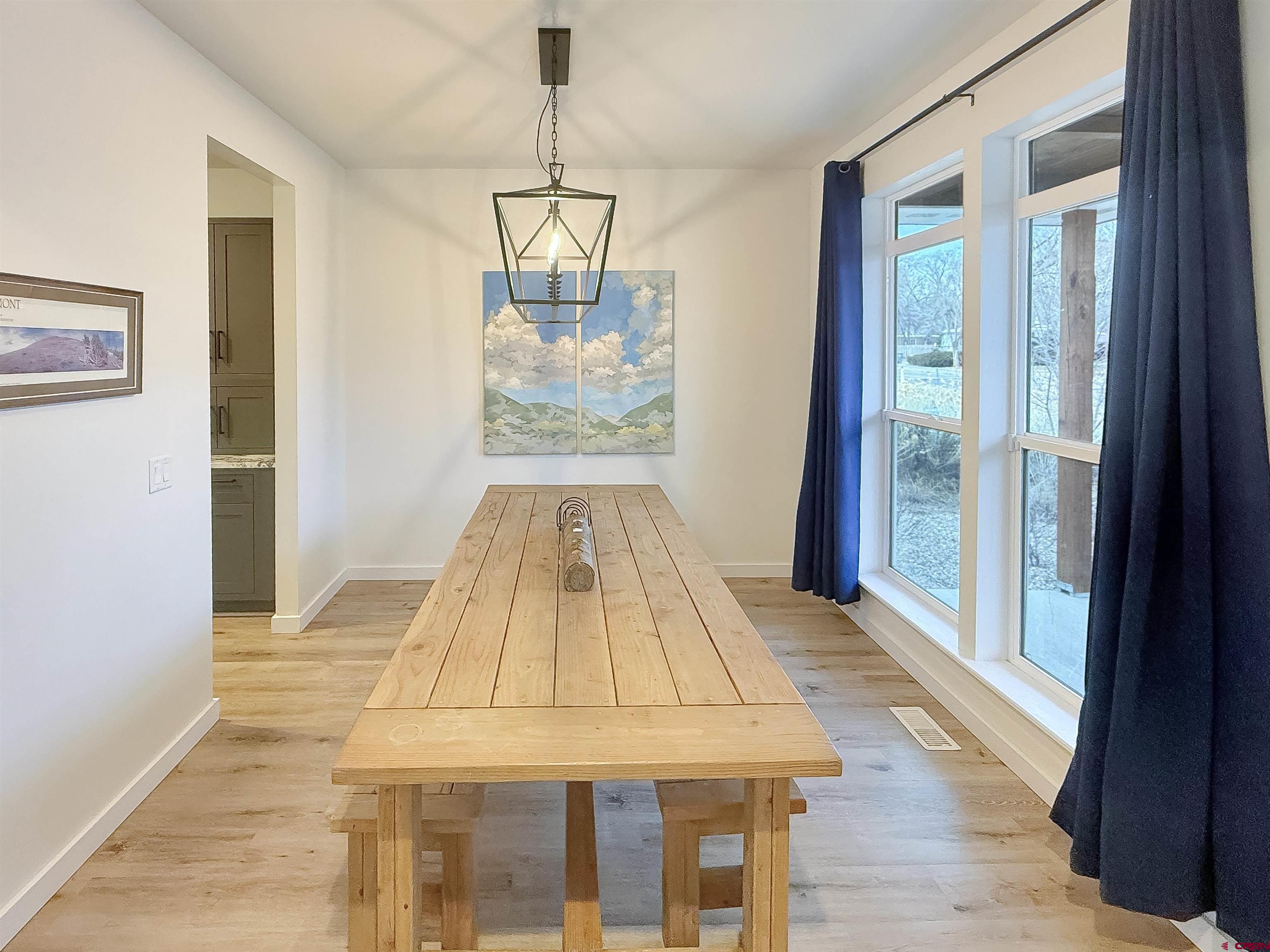 903 South Oak Street Cortez, CO 81321 - Photo 16 of 44 a view of empty room with wooden floor and chandelier