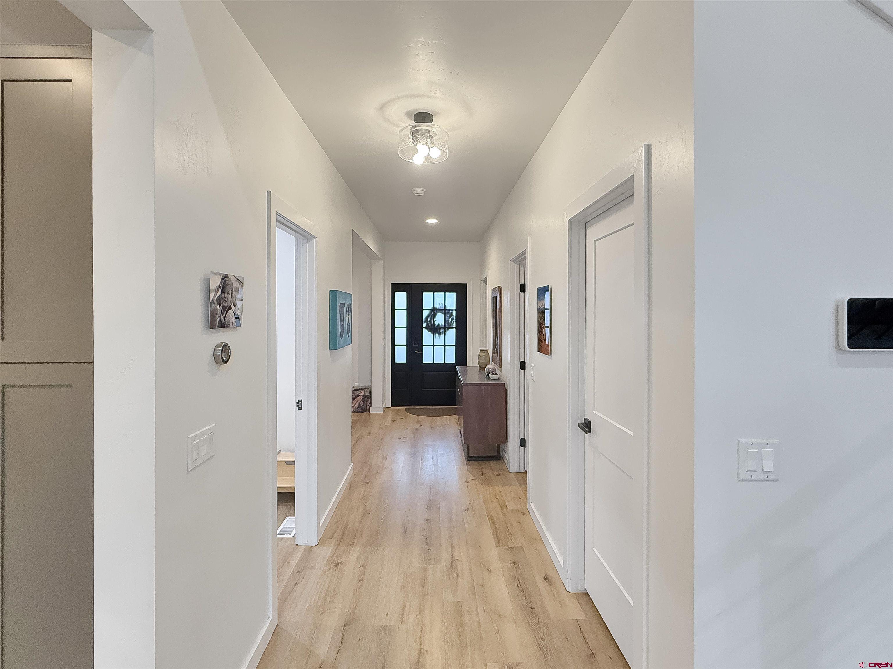 903 South Oak Street Cortez, CO 81321 - Photo 17 of 44 a view of a hallway with wooden floor