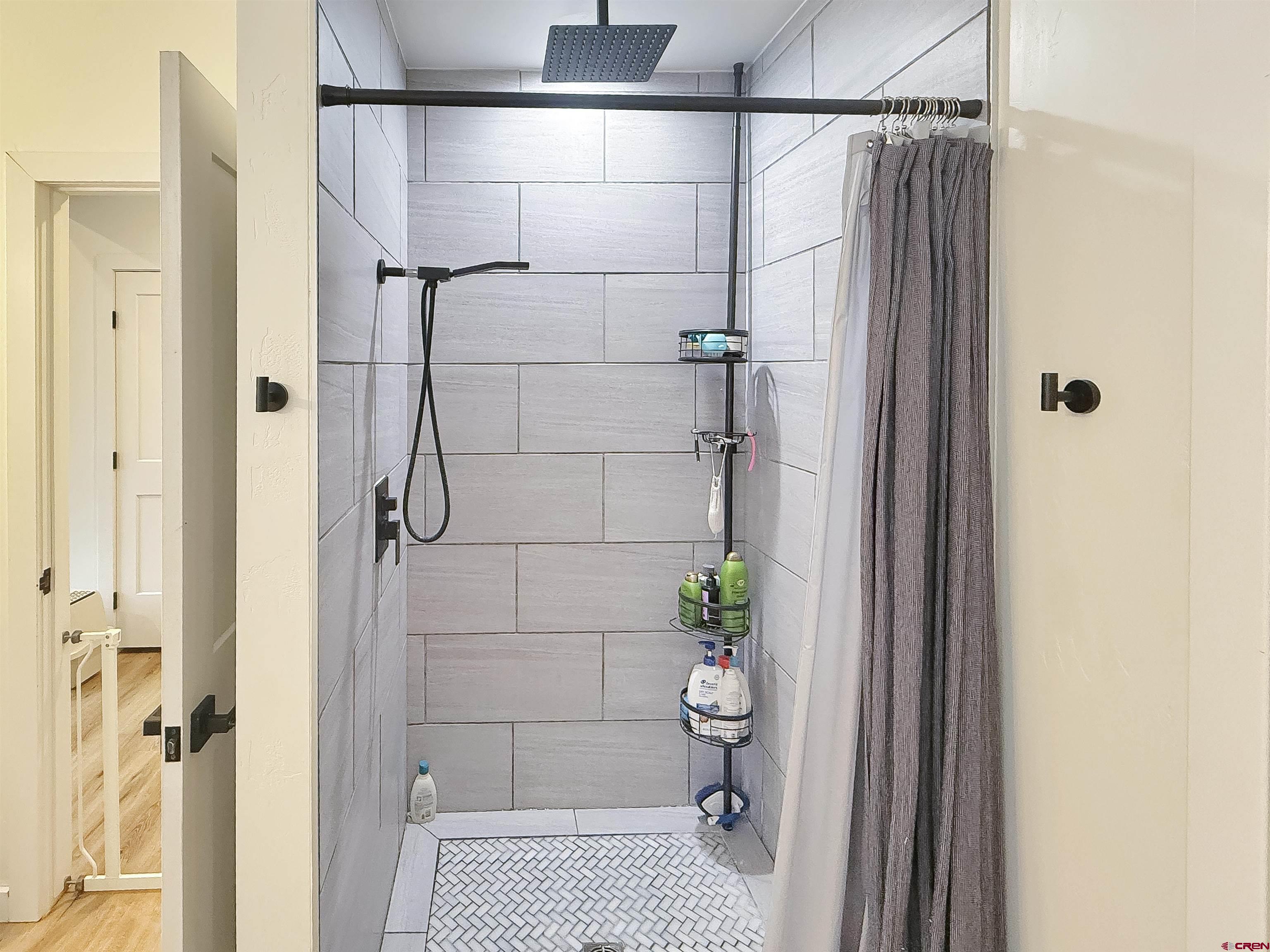 903 South Oak Street Cortez, CO 81321 - Photo 24 of 44 a bathroom with a shower and toilet