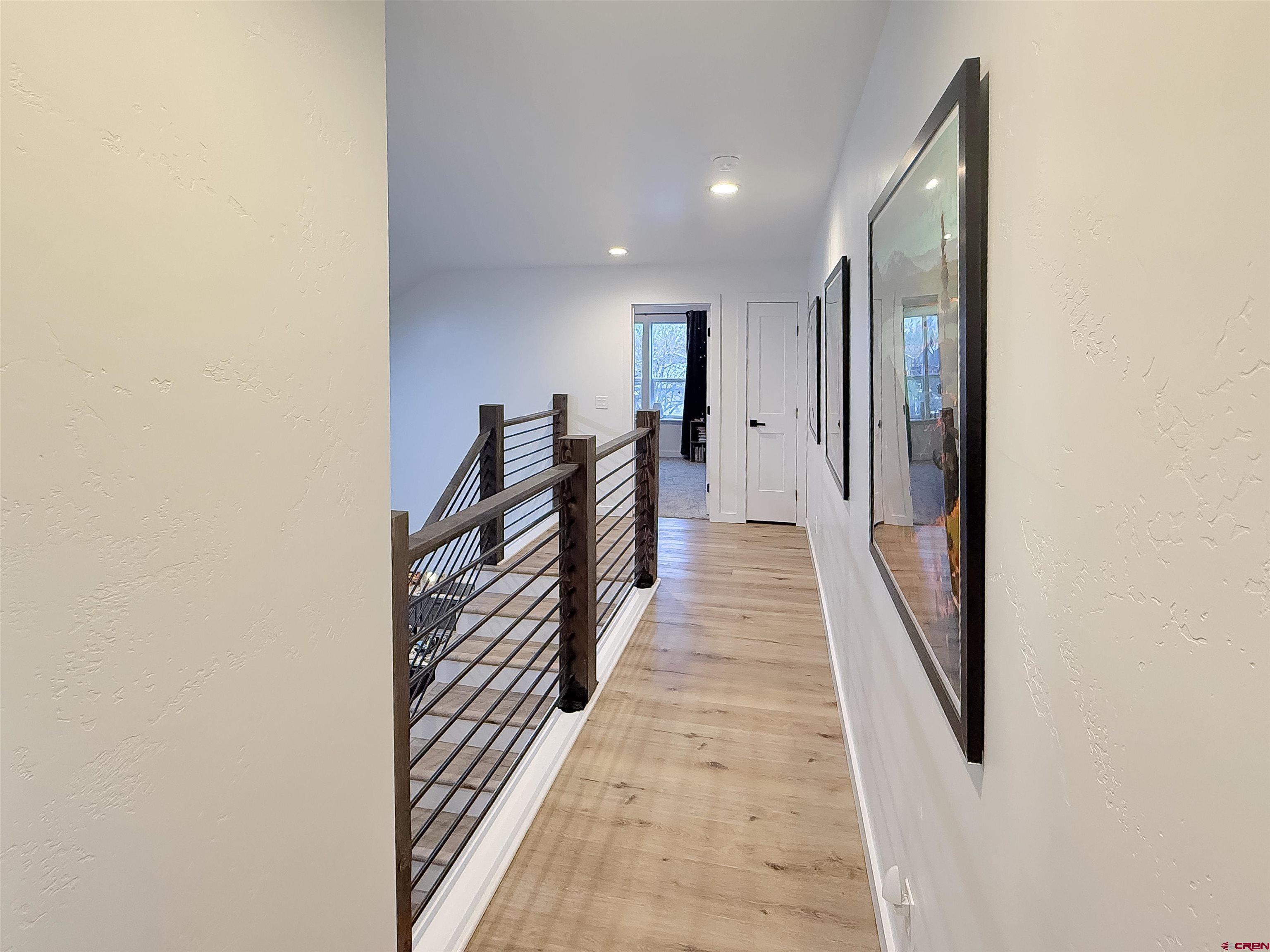 903 South Oak Street Cortez, CO 81321 - Photo 28 of 44 a view of a hallway with wooden floor and stairs