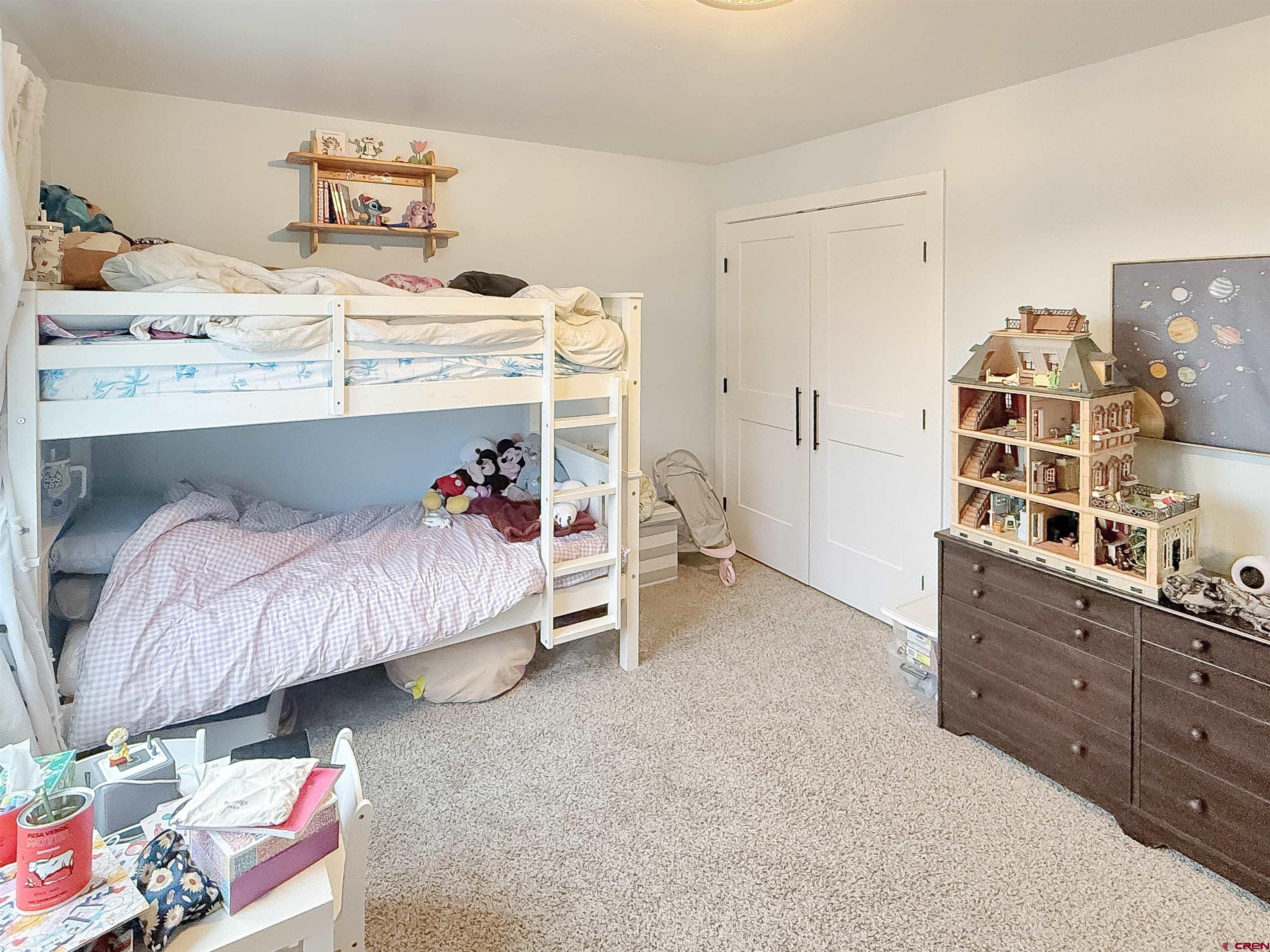 903 South Oak Street Cortez, CO 81321 - Photo 31 of 44 a bed room with a bed and a chair