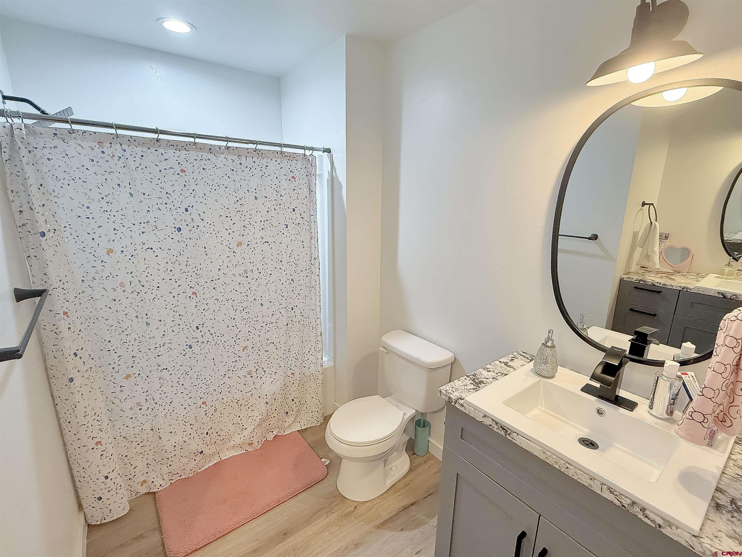 903 South Oak Street Cortez, CO 81321 - Photo 33 of 44 a bathroom with a sink a toilet and a mirror