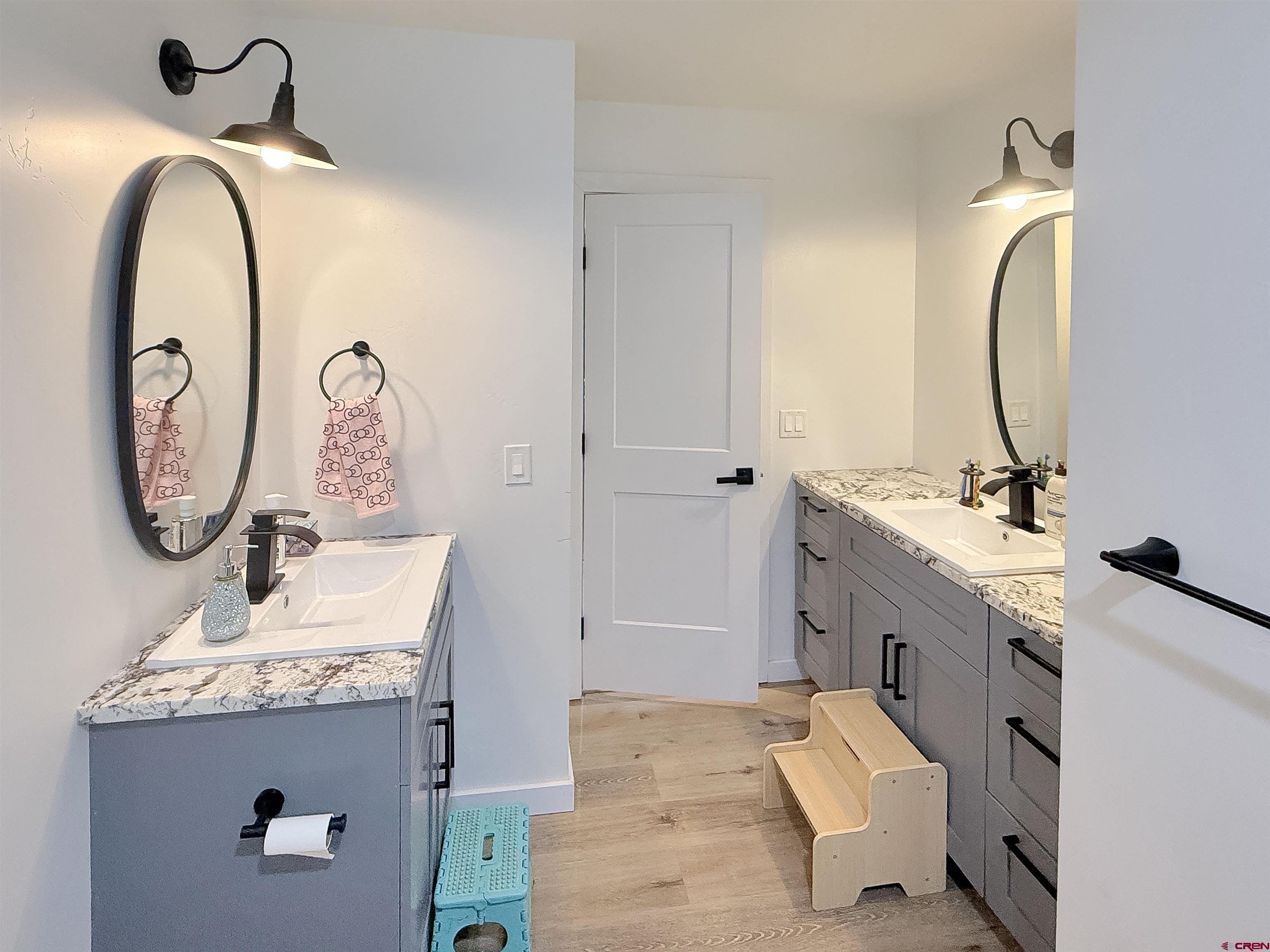903 South Oak Street Cortez, CO 81321 - Photo 34 of 44 a bathroom with a sink and a mirror