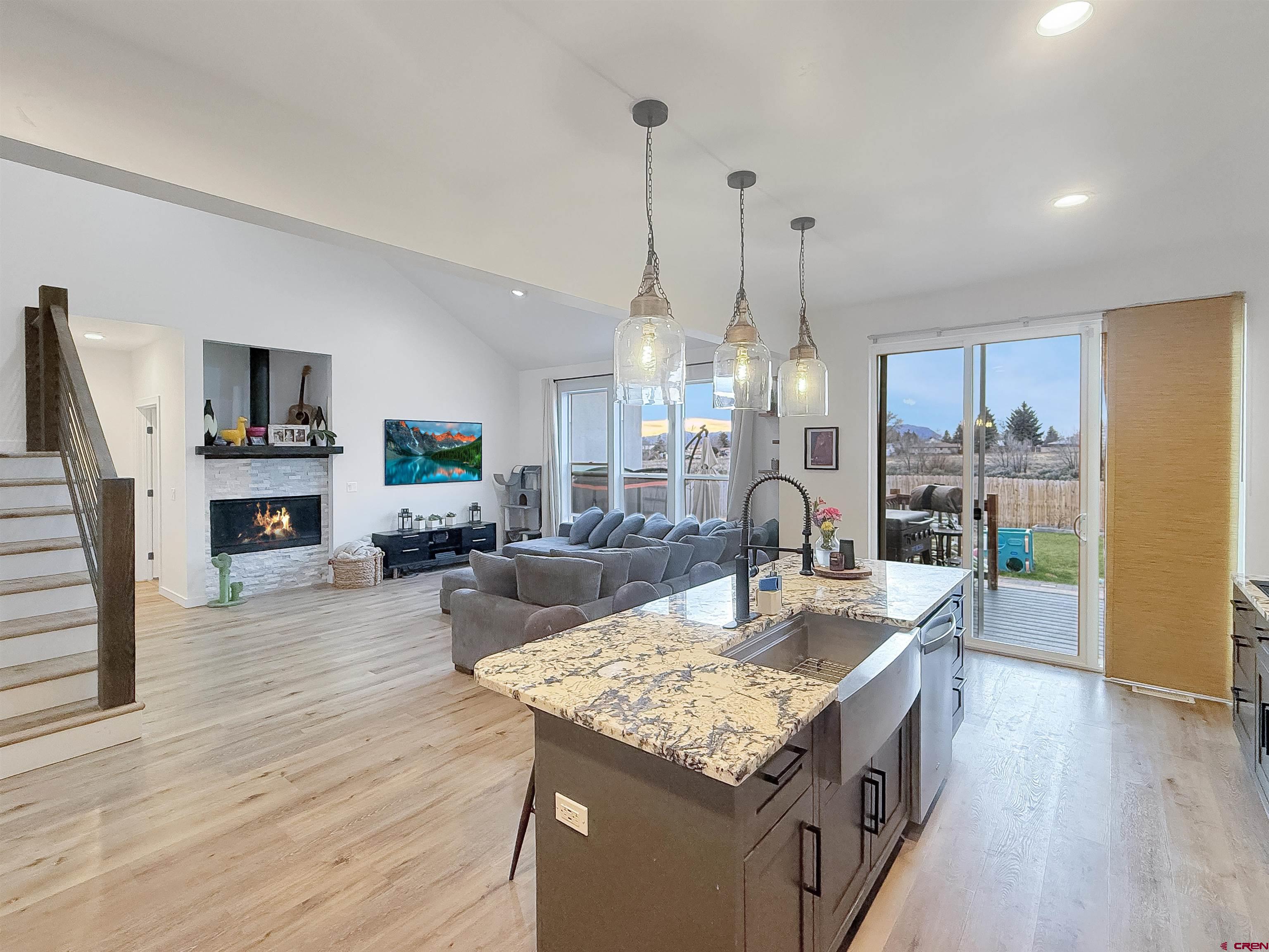 903 South Oak Street Cortez, CO 81321 - Photo 9 of 44 a living room with fireplace furniture and a wooden floor