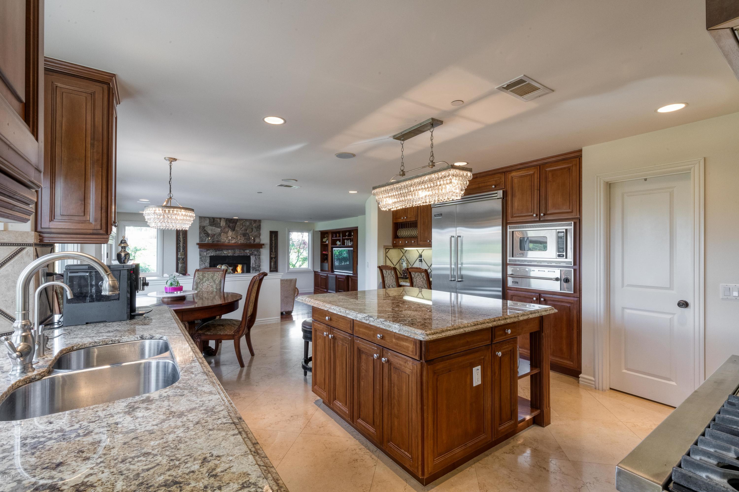 25741 Piuma Road Calabasas, CA 91302 - Photo 11 of 38 a kitchen with kitchen island granite countertop a sink counter top space appliances and cabinets