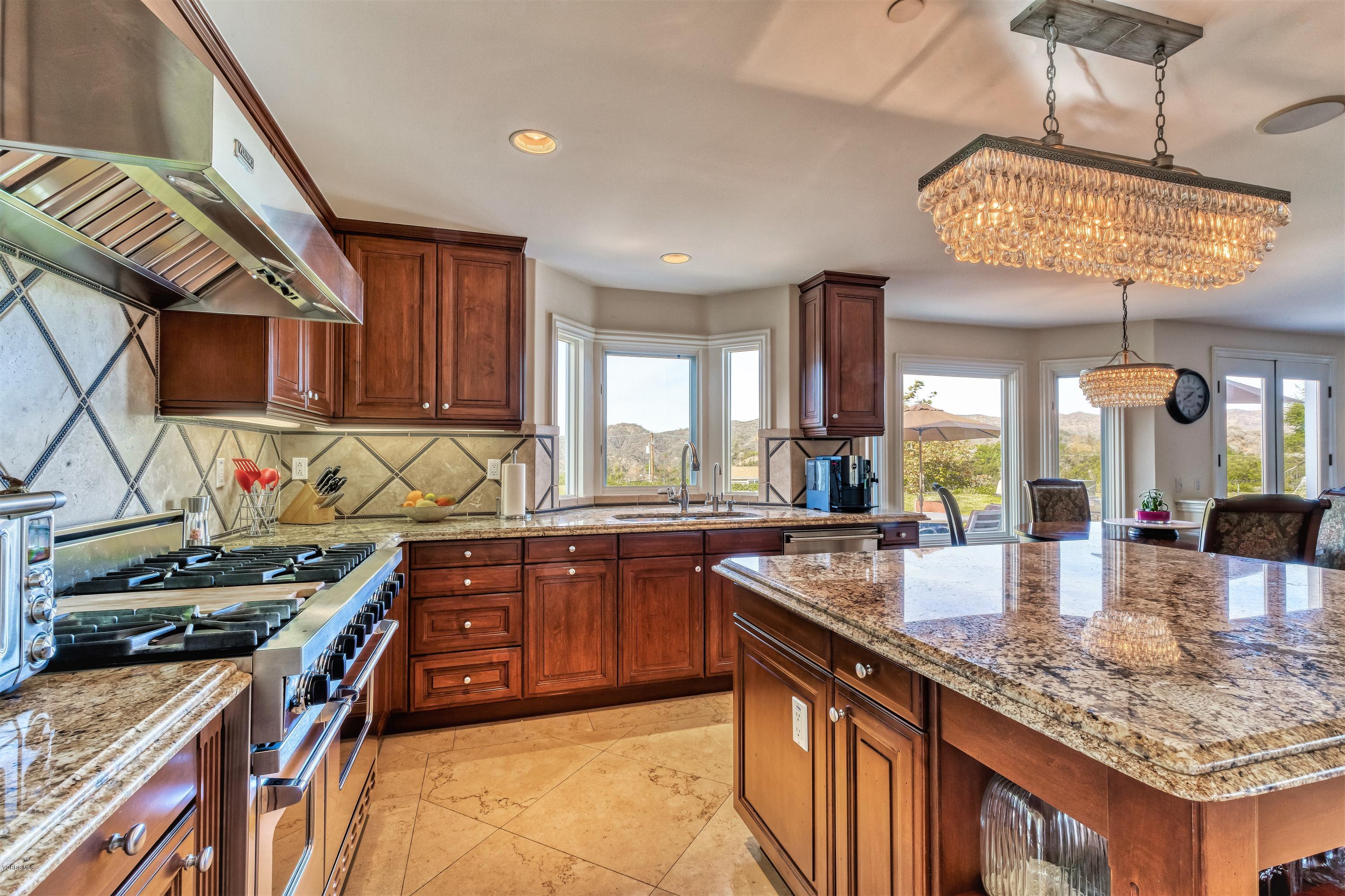 25741 Piuma Road Calabasas, CA 91302 - Photo 12 of 38 a kitchen with stainless steel appliances granite countertop a stove and a sink