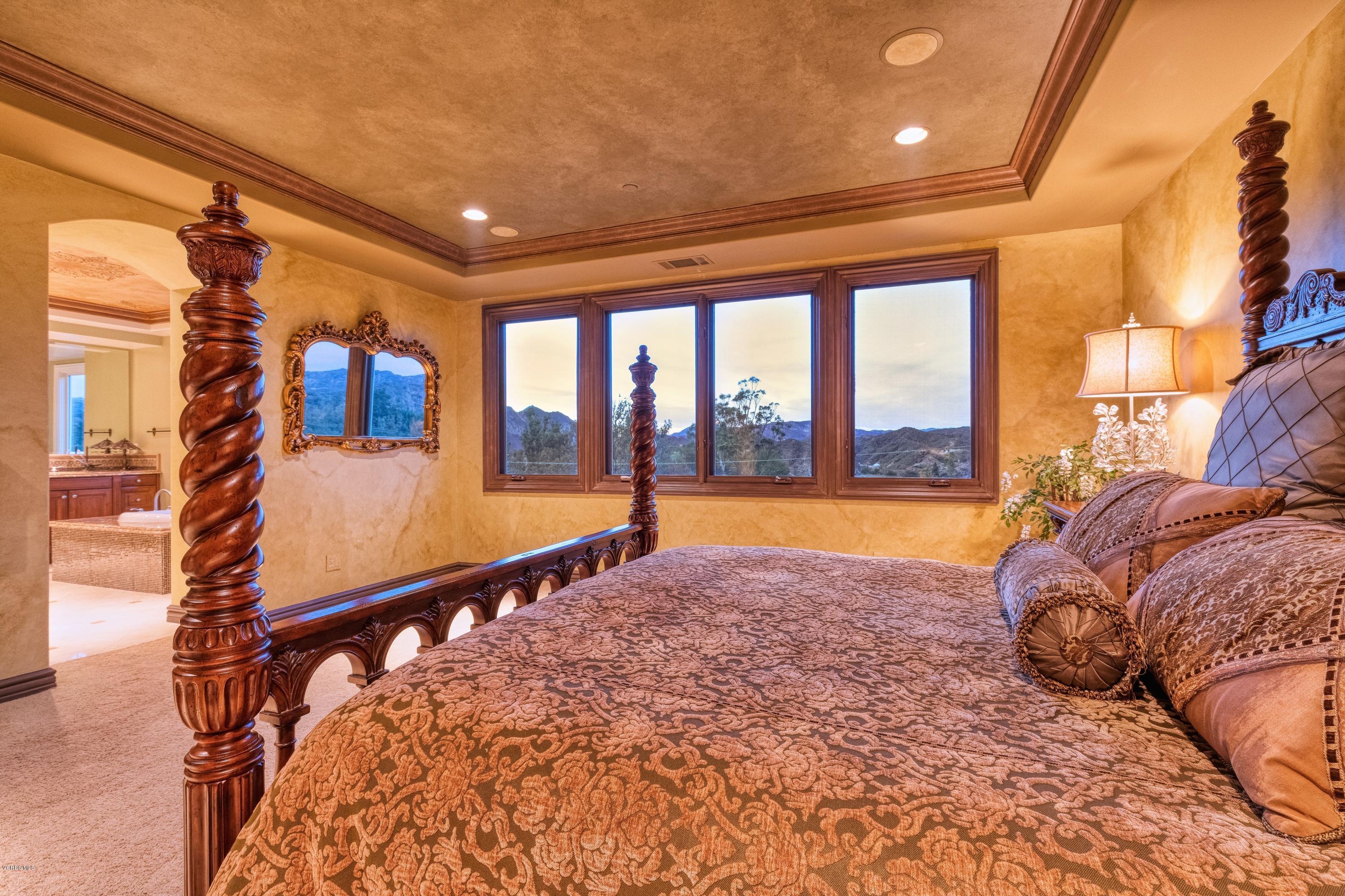 25741 Piuma Road Calabasas, CA 91302 - Photo 16 of 38 a spacious bedroom with a large bed and a large window