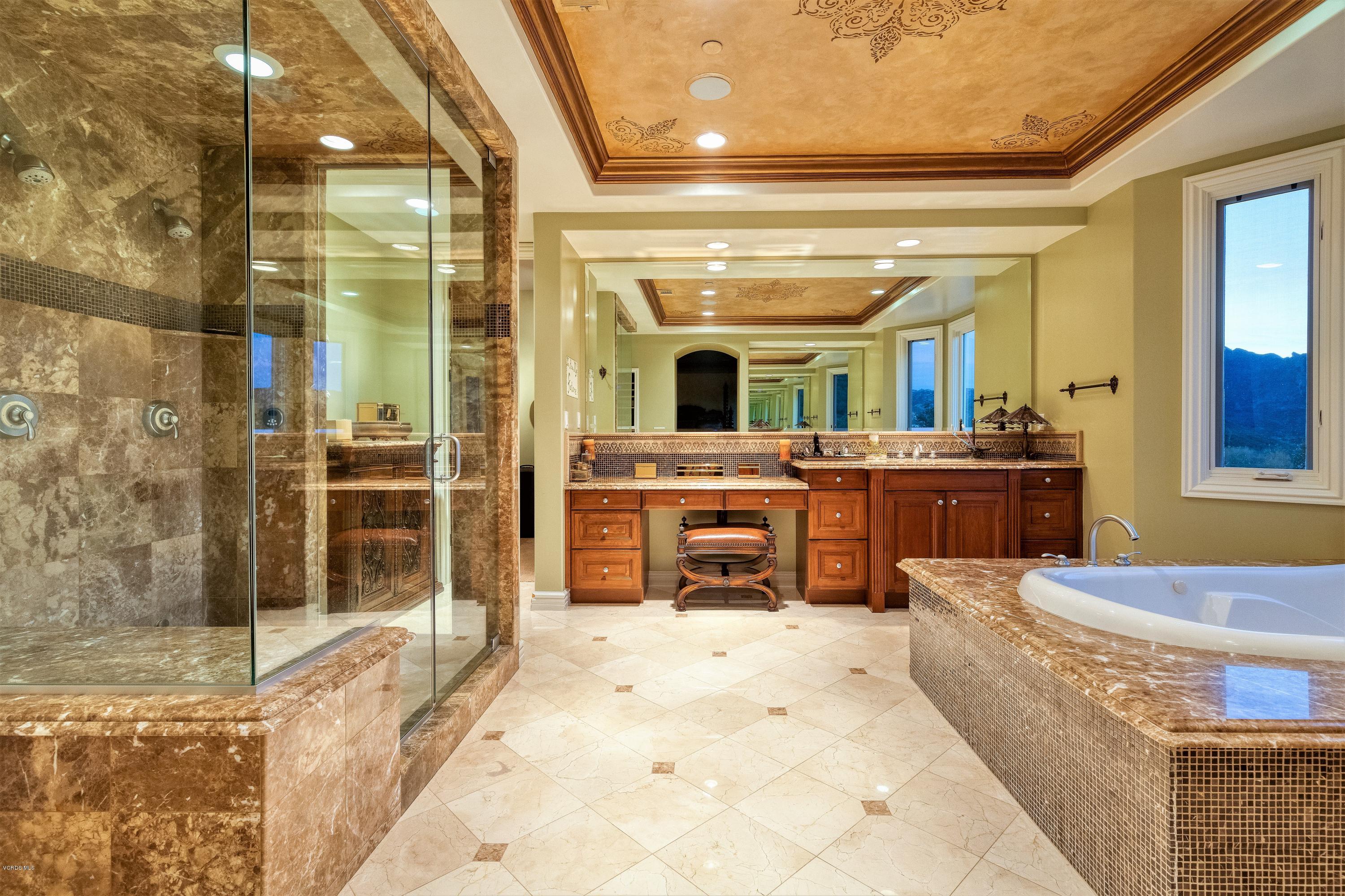 25741 Piuma Road Calabasas, CA 91302 - Photo 17 of 38 a bathroom with a tub sink and mirror