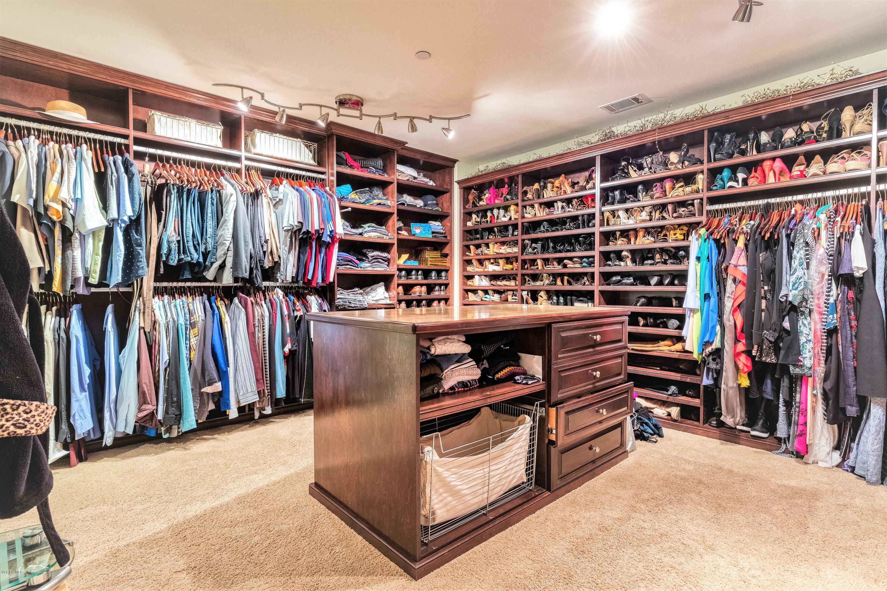 25741 Piuma Road Calabasas, CA 91302 - Photo 21 of 38 a view of walk in closet with clothes and shoes