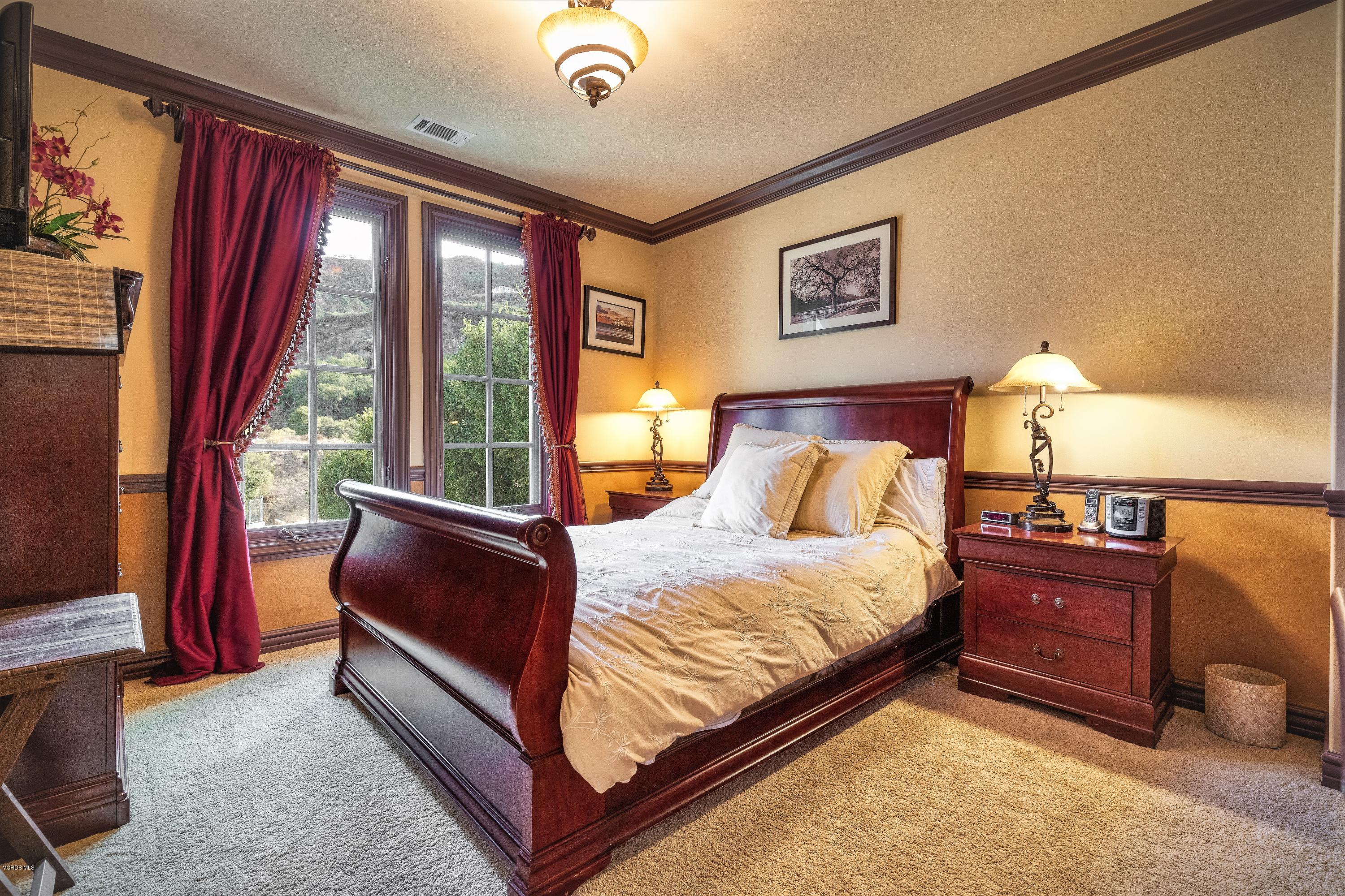 25741 Piuma Road Calabasas, CA 91302 - Photo 25 of 38 a bed sitting in a spacious bedroom next to a window