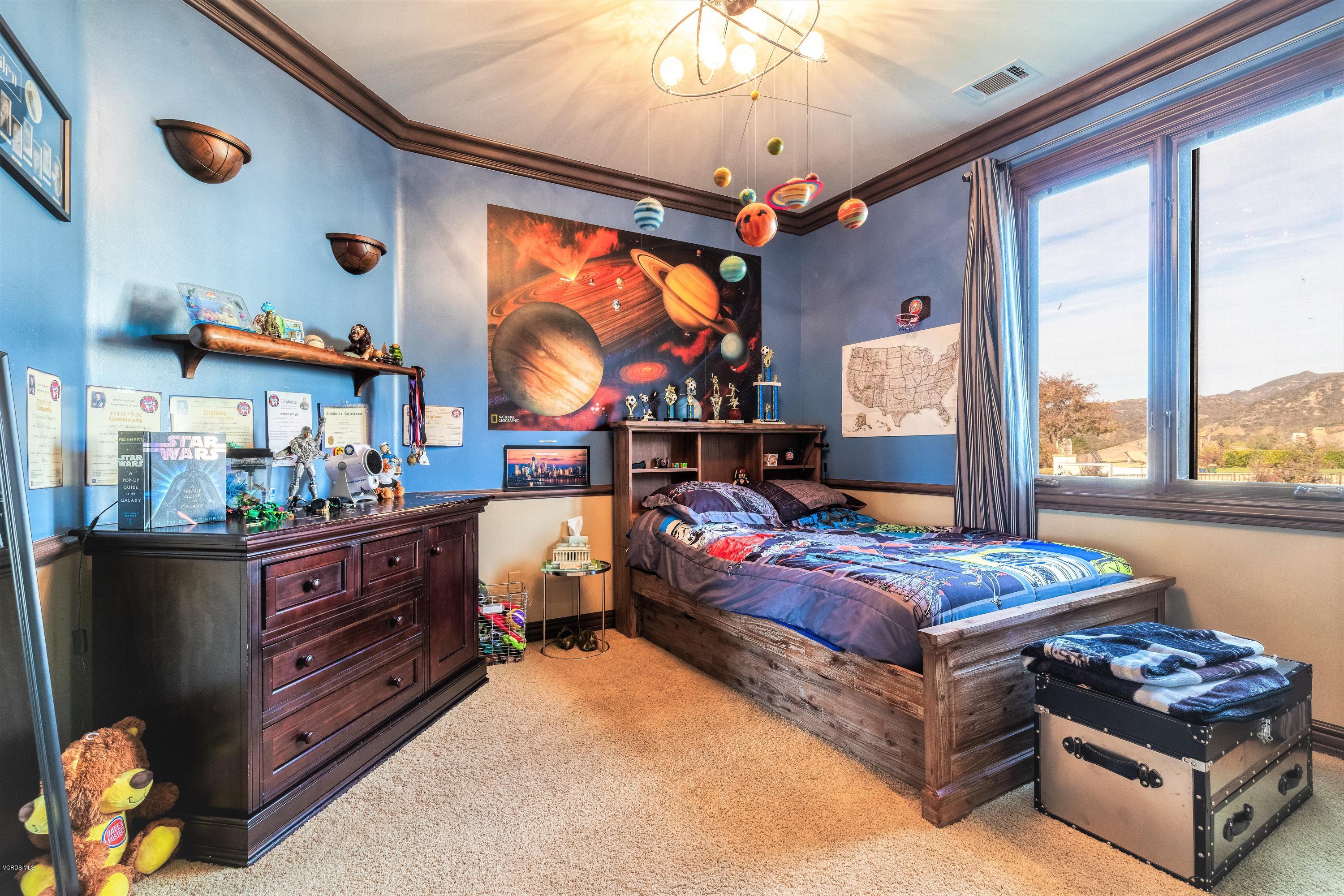 25741 Piuma Road Calabasas, CA 91302 - Photo 31 of 38 a bedroom with furniture and a flat screen tv