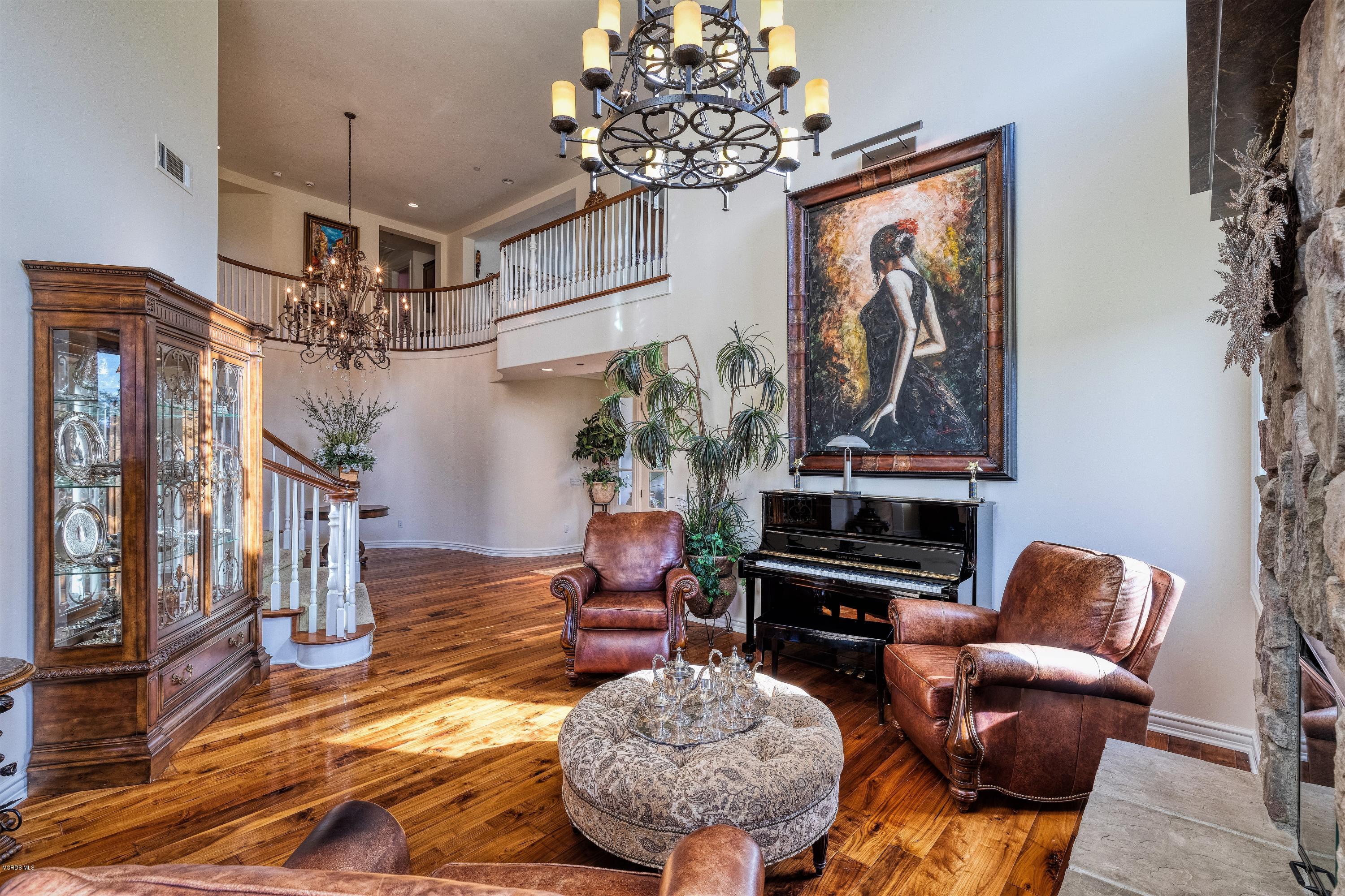 25741 Piuma Road Calabasas, CA 91302 - Photo 8 of 38 a living room with furniture flowers and a chandelier