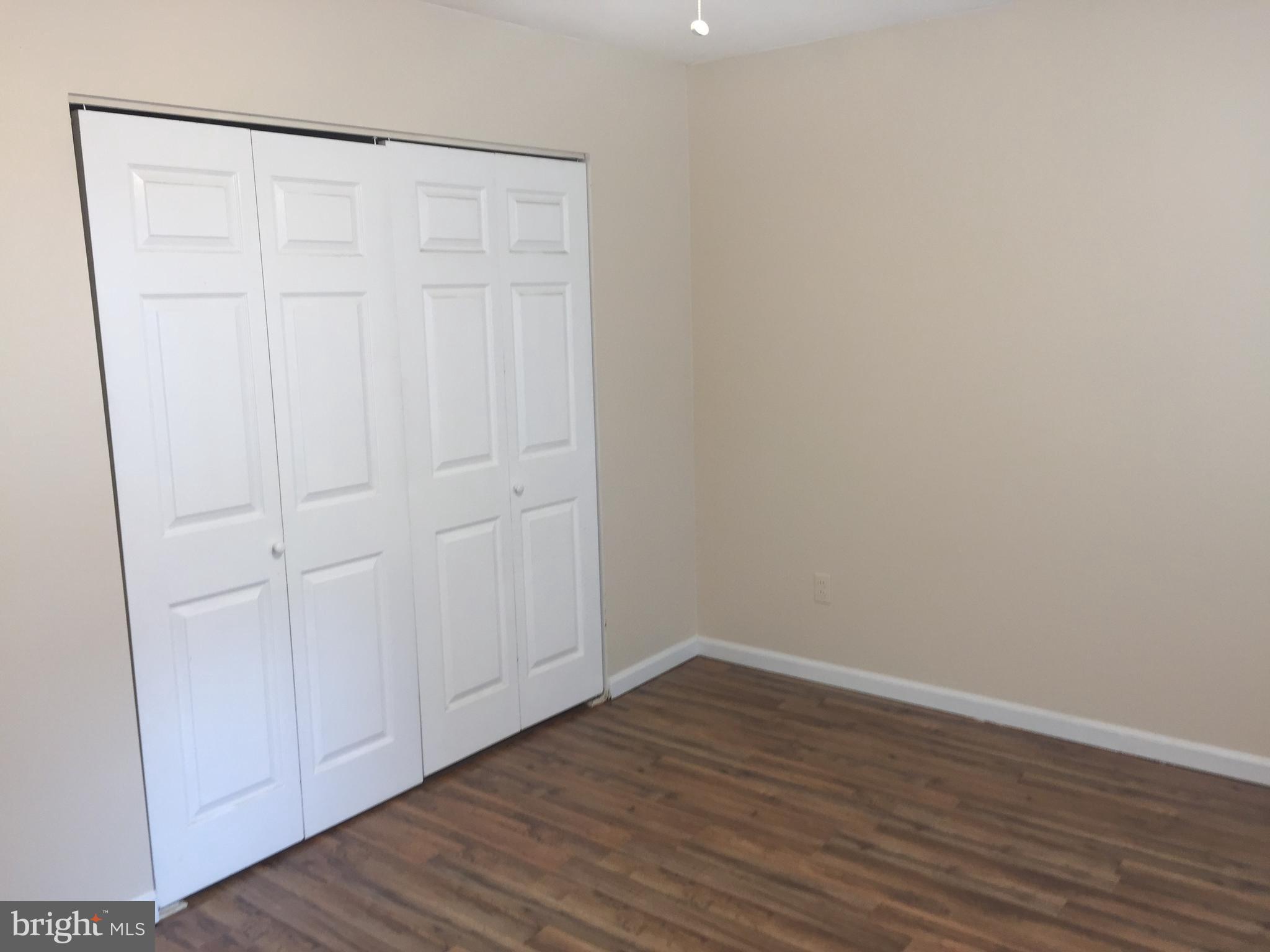 1329 Willow Spring Road Baltimore, MD 21228 - Photo 8 of 24 a view of an empty room with wooden floor