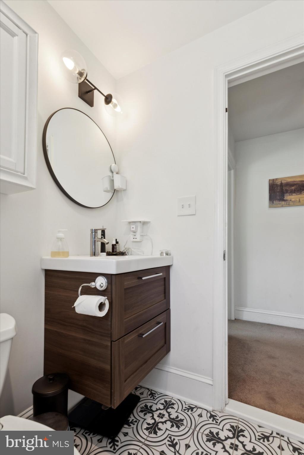 322 Woodbine Avenue Narberth, PA 19072 - Photo 15 of 26 a bathroom with a sink mirror vanity and toilet
