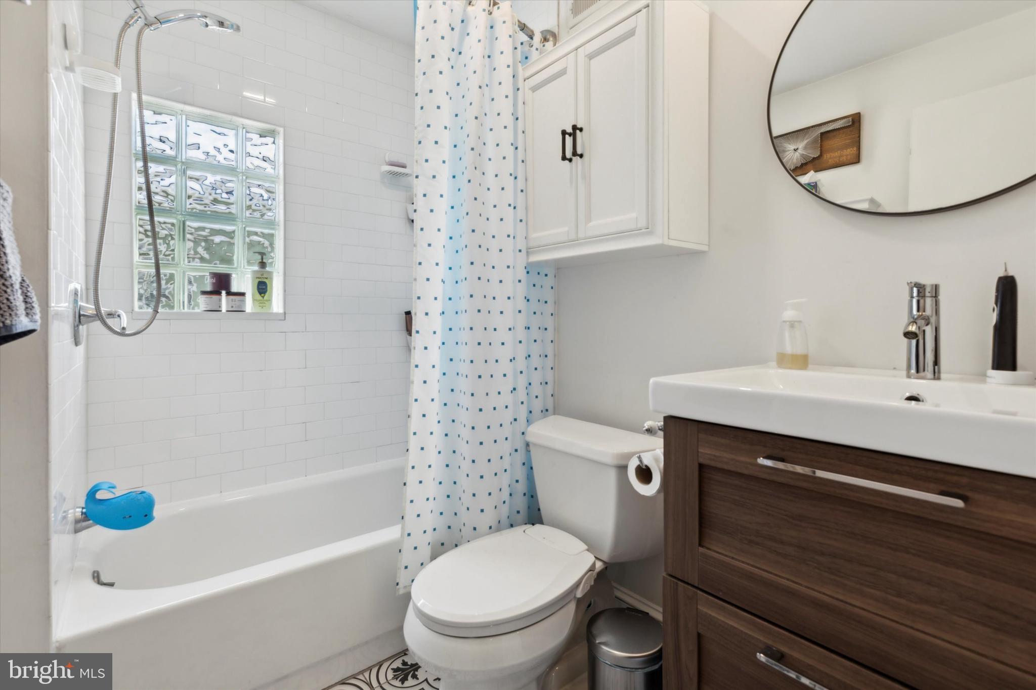 322 Woodbine Avenue Narberth, PA 19072 - Photo 16 of 26 a bathroom with a sink a toilet and a mirror