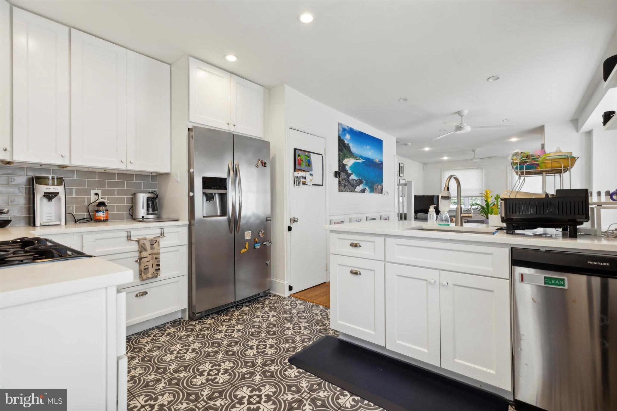 322 Woodbine Avenue Narberth, PA 19072 - Photo 10 of 26 a kitchen with white cabinets and stainless steel appliances