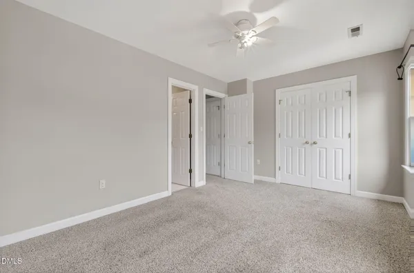 a view of an empty room with a ceiling fan