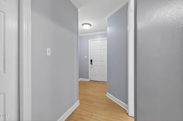 a view of a hallway with wooden floor