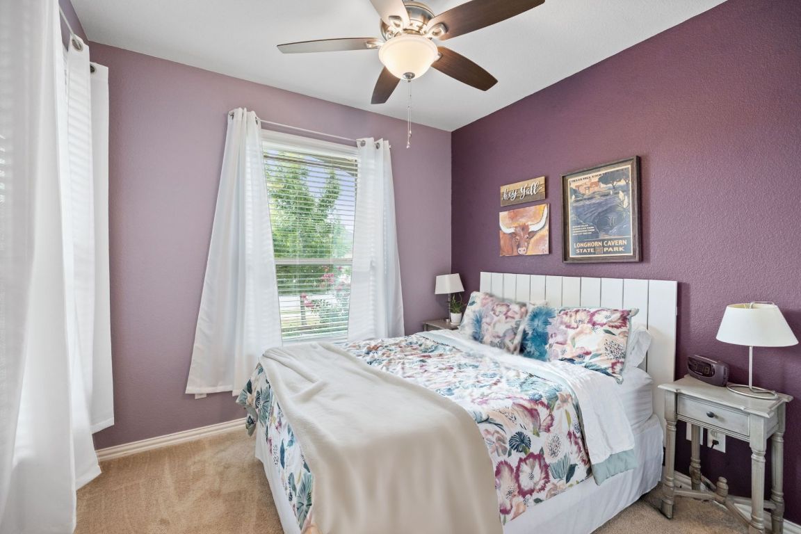 454 Shale Circle Buda, TX 78610 - Photo 12 of 27 a bedroom with a bed and a window