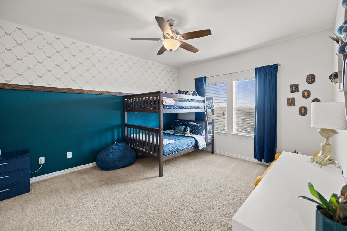 454 Shale Circle Buda, TX 78610 - Photo 15 of 27 a bedroom with furniture and a ceiling fan