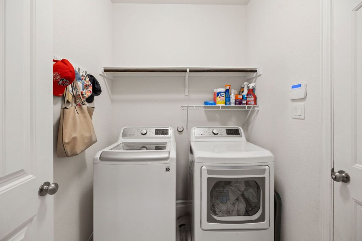 454 Shale Circle Buda, TX 78610 - Photo 22 of 27 a utility room with dryer and washer