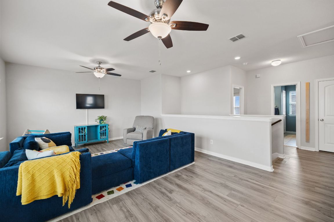 454 Shale Circle Buda, TX 78610 - Photo 8 of 27 a living room with furniture and a flat screen tv
