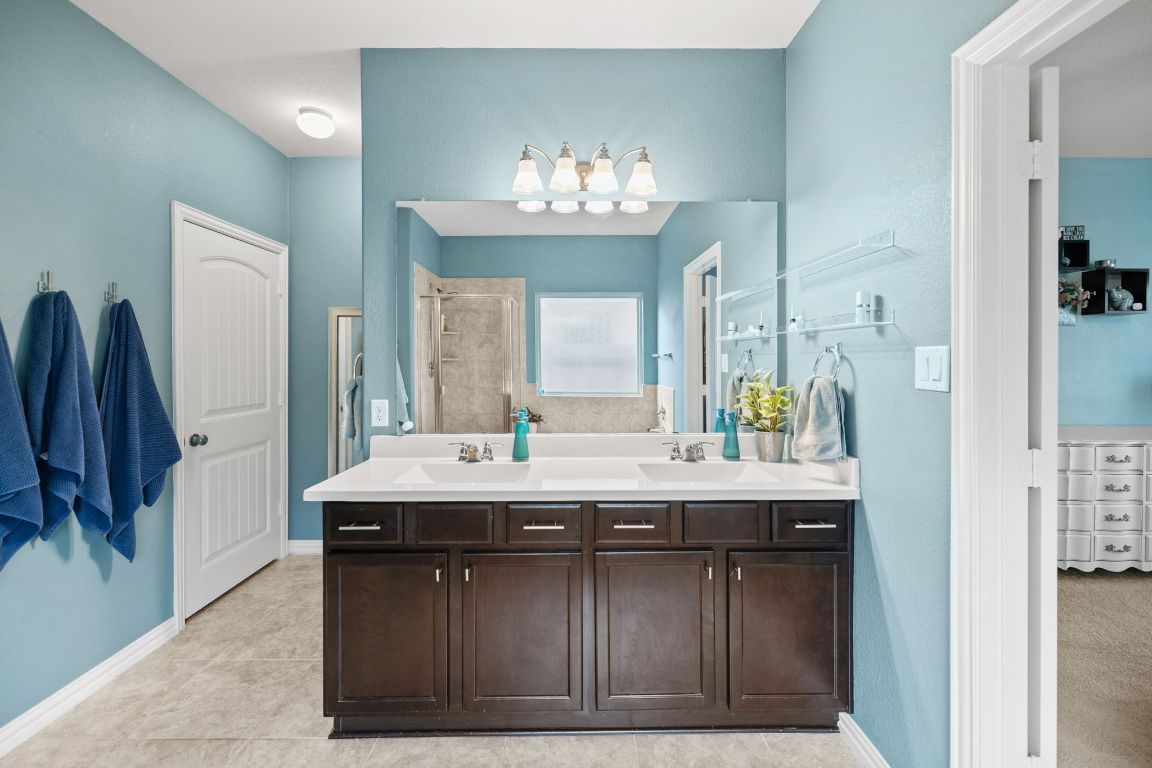 454 Shale Circle Buda, TX 78610 - Photo 10 of 27 a bathroom with a sink double vanity granite and a mirror