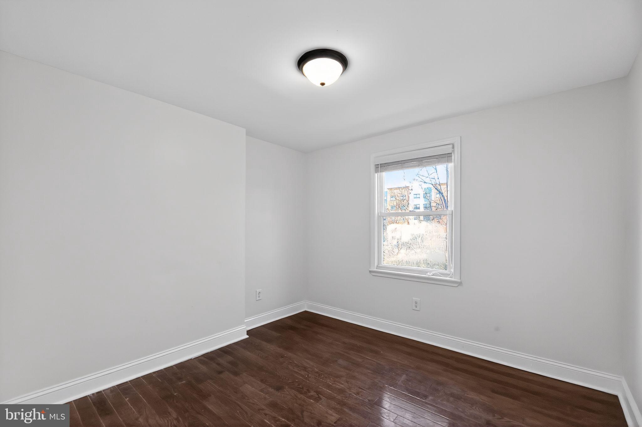 2413 North Carlisle Street Philadelphia, PA 19132 - Photo 11 of 30 a view of an empty room with wooden floor and a window