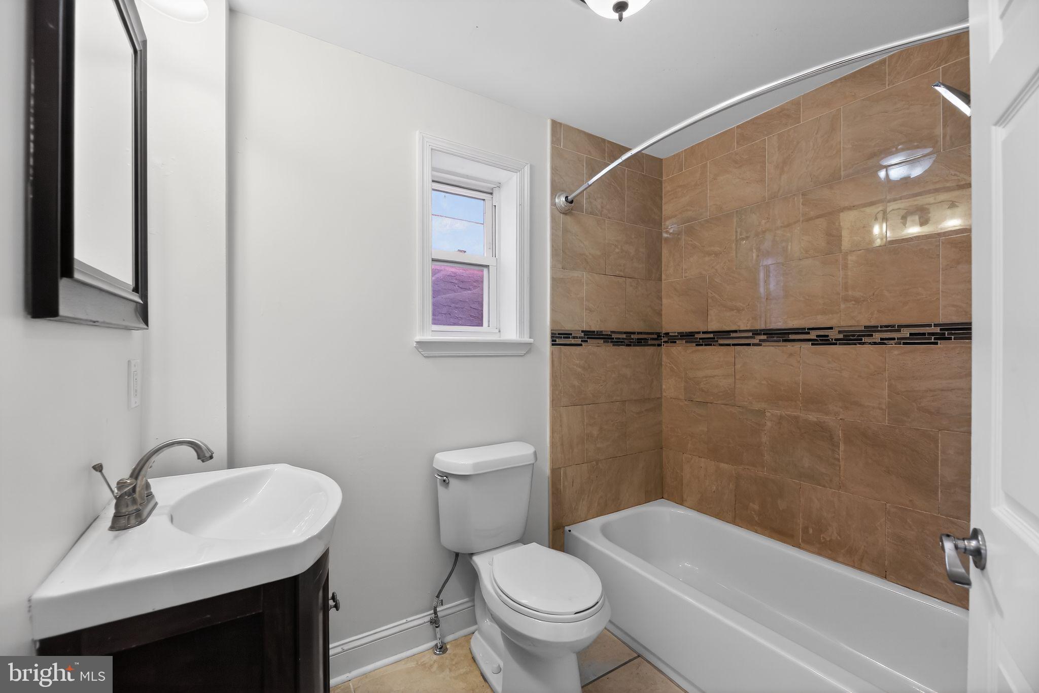 2413 North Carlisle Street Philadelphia, PA 19132 - Photo 19 of 30 a bathroom with a sink toilet and shower