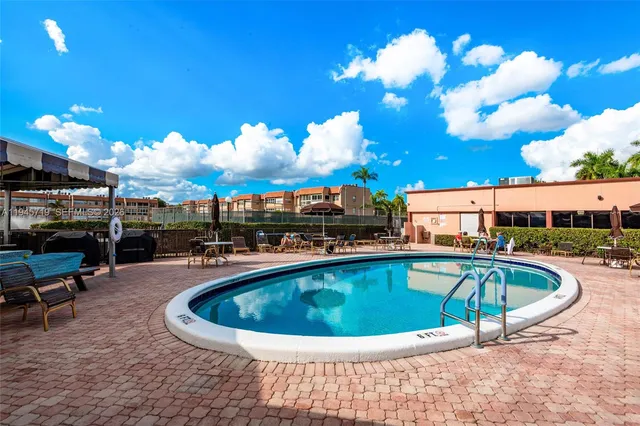 a view of a swimming pool having outdoor seating