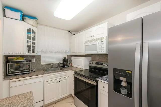 a kitchen with a refrigerator stove and sink